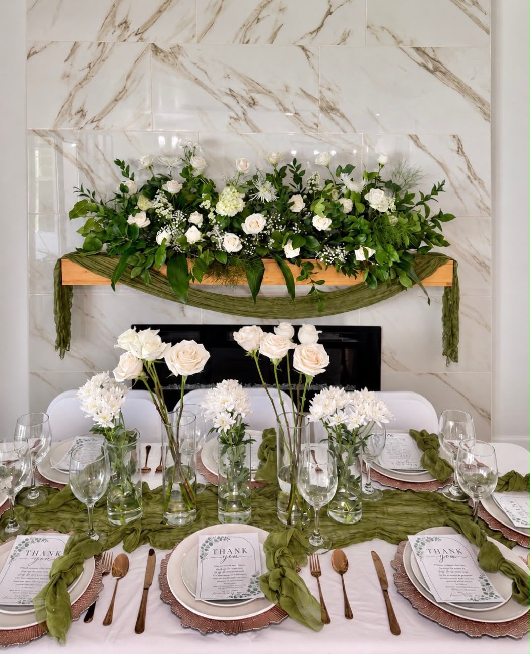 Elegant white rose and green florals tablescape with rose-gold chargers by LUX Event Design