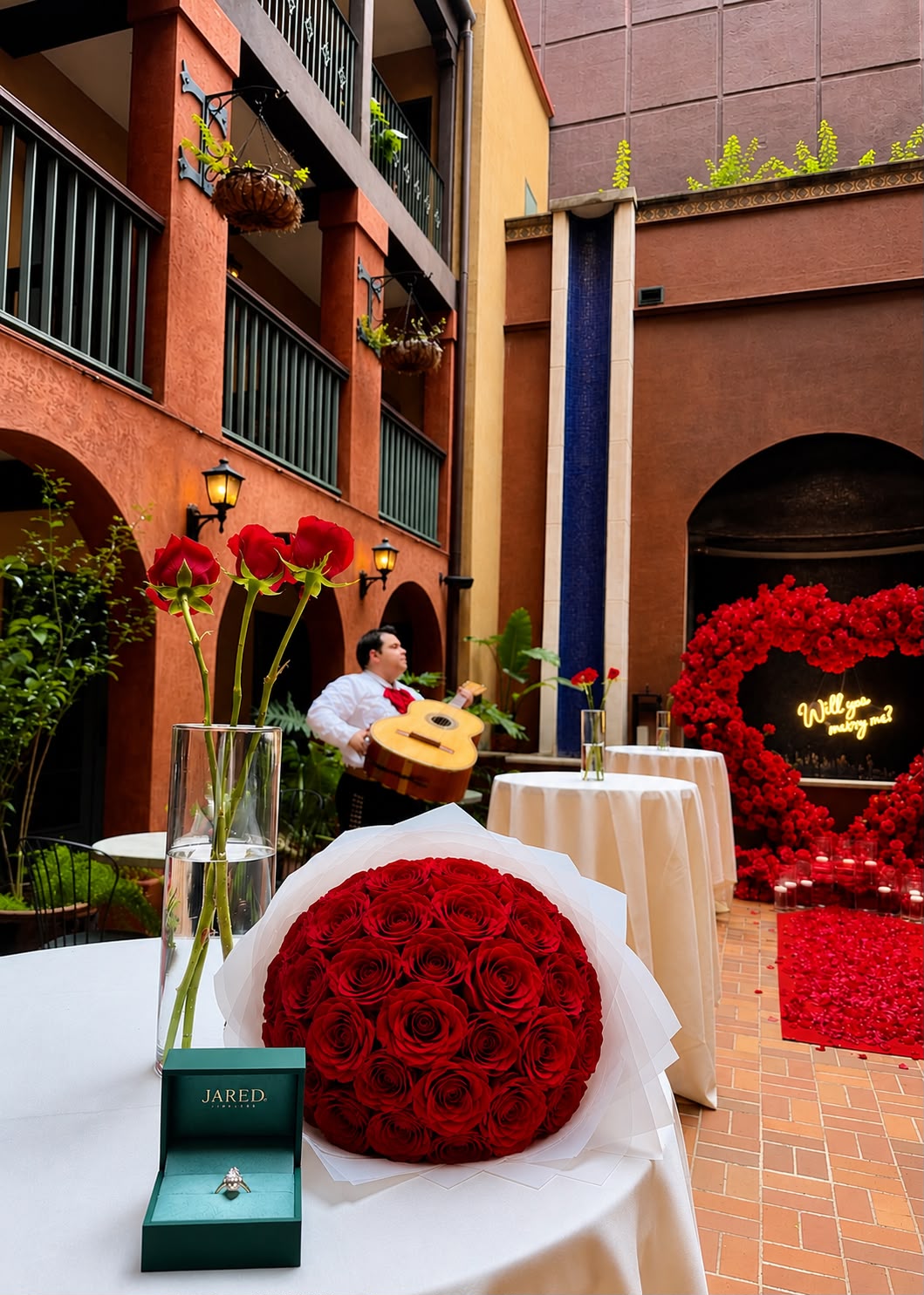 Romantic rose proposal setup with heart arch and red rose runner by LUX Event Design